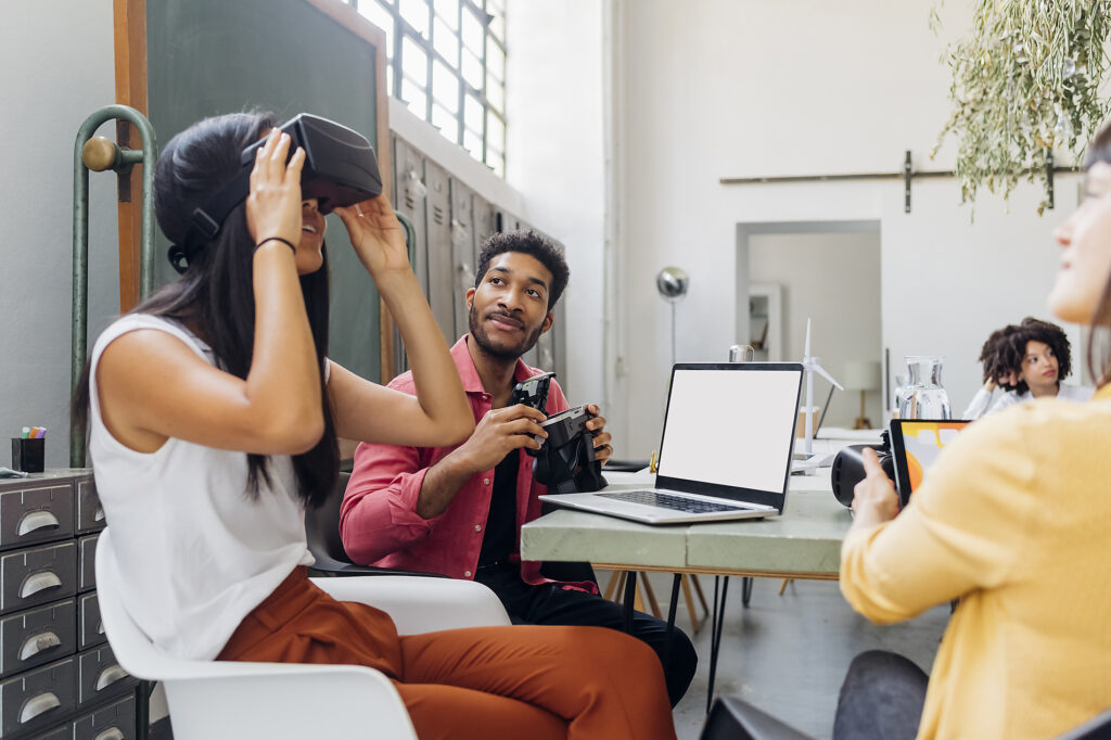 Businesswoman watching VR goggles by colleague at workplace
Royalty-free image