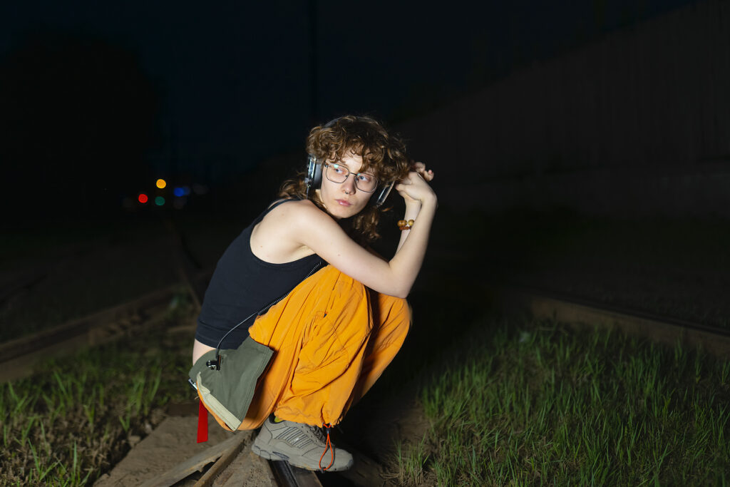 Music fan squatting on tram track with headphone in the evening
Royalty-free image
