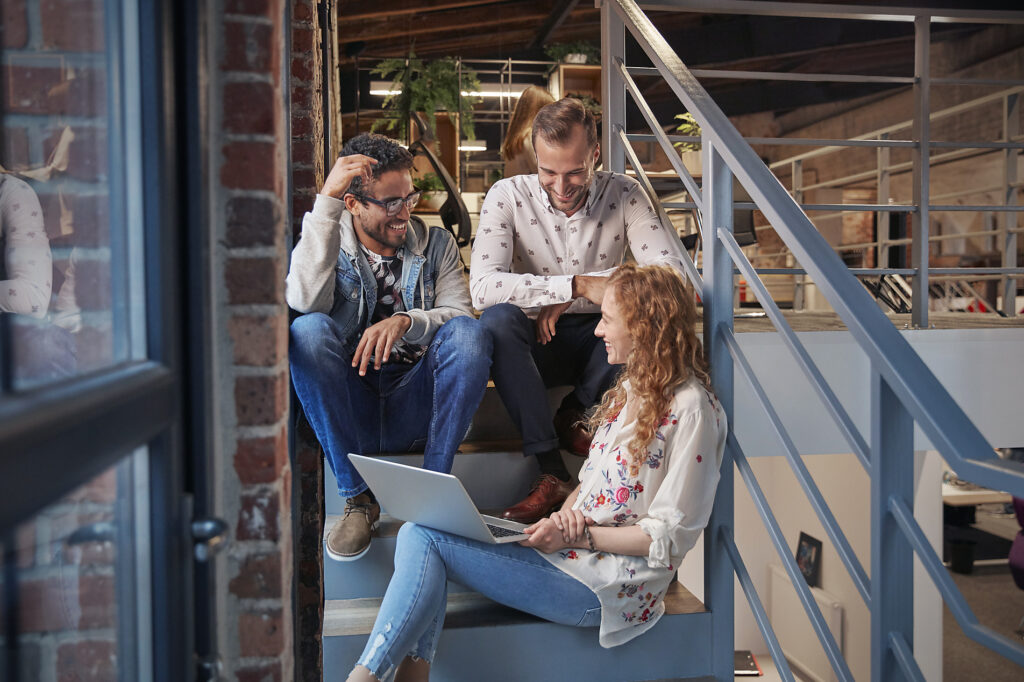 Young business people sitting on stairs in loft office using laptop
Royalty-free image
