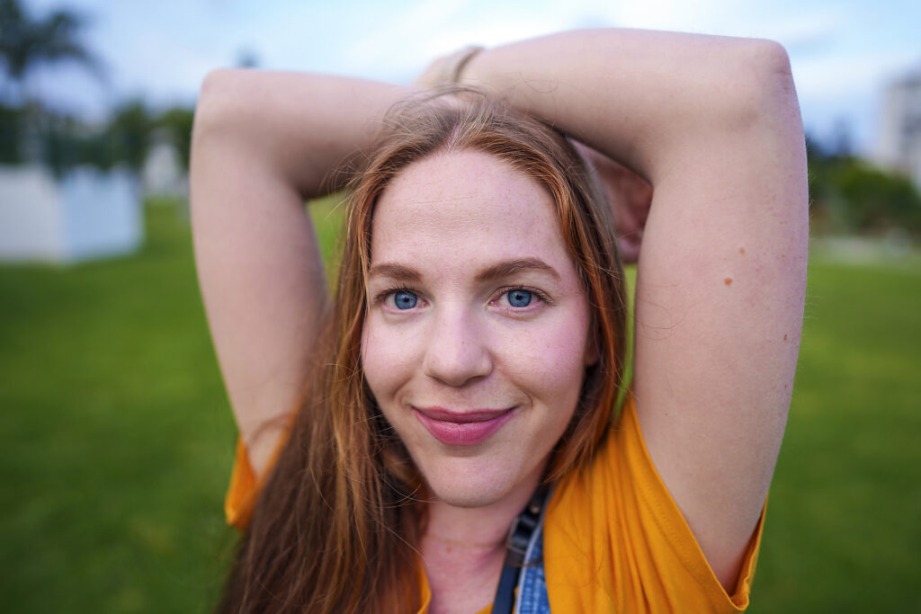 Woman smiling and stretching outdoors in a green park
Royalty-free image