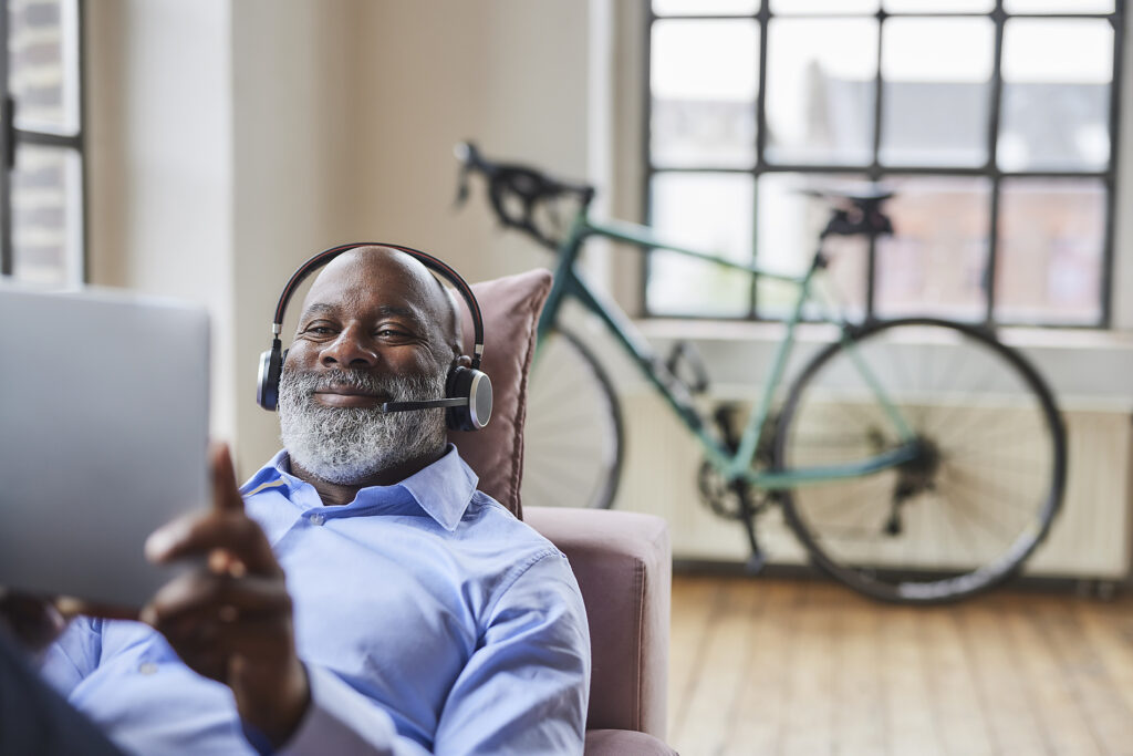 Smiling businessman with headset on video call through tablet PC at home Royalty-free image Smiling businessman with headset on video call through tablet PC at home
Royalty-free image