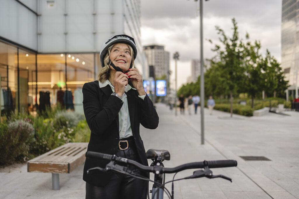 Businesswoman fastening helmet before cycling on city street Royalty-free image Businesswoman fastening helmet before cycling on city street
Royalty-free image