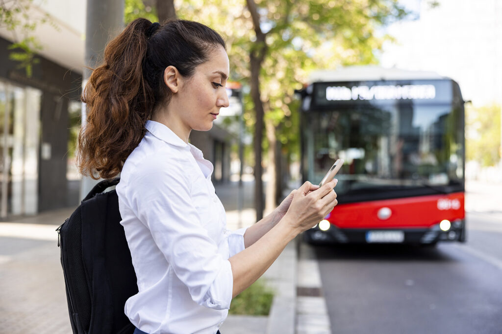 Businesswoman using smart phone standing in front of bus Royalty-free image Businesswoman using smart phone standing in front of bus
Royalty-free image