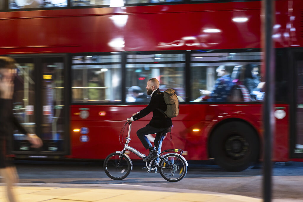 Man cycling near bus in city at night Royalty-free image Man cycling near bus in city at night
Royalty-free image