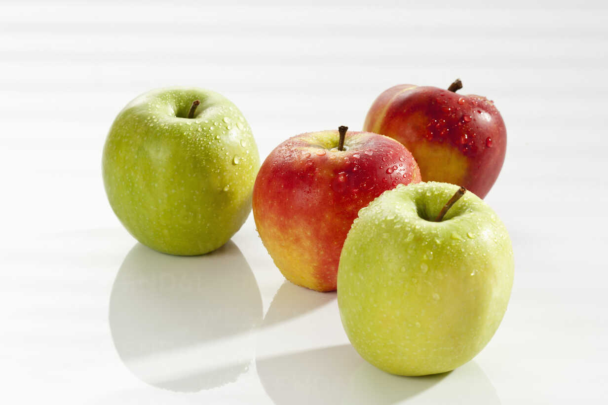 Red and green apples on white background, close up stock photo