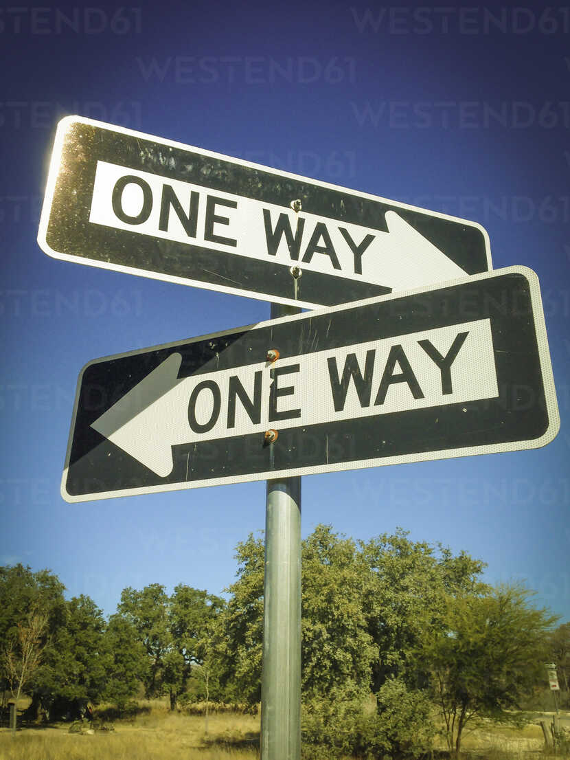 Two One Way Signs pointing in opposite directions stock photo