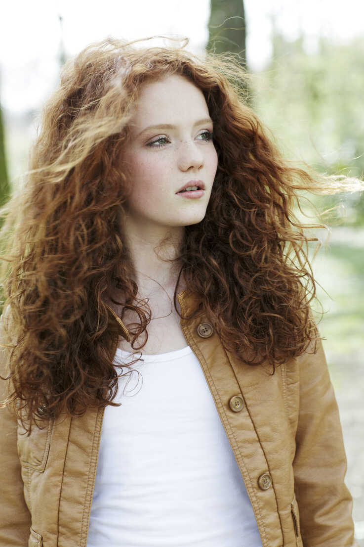 Portrait of girl with curly red hair stock photo
