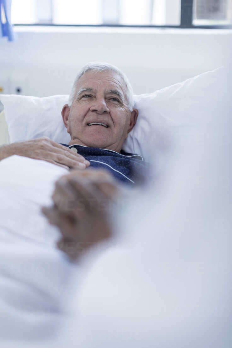 Doctor visiting hospital patient at bed stock photo