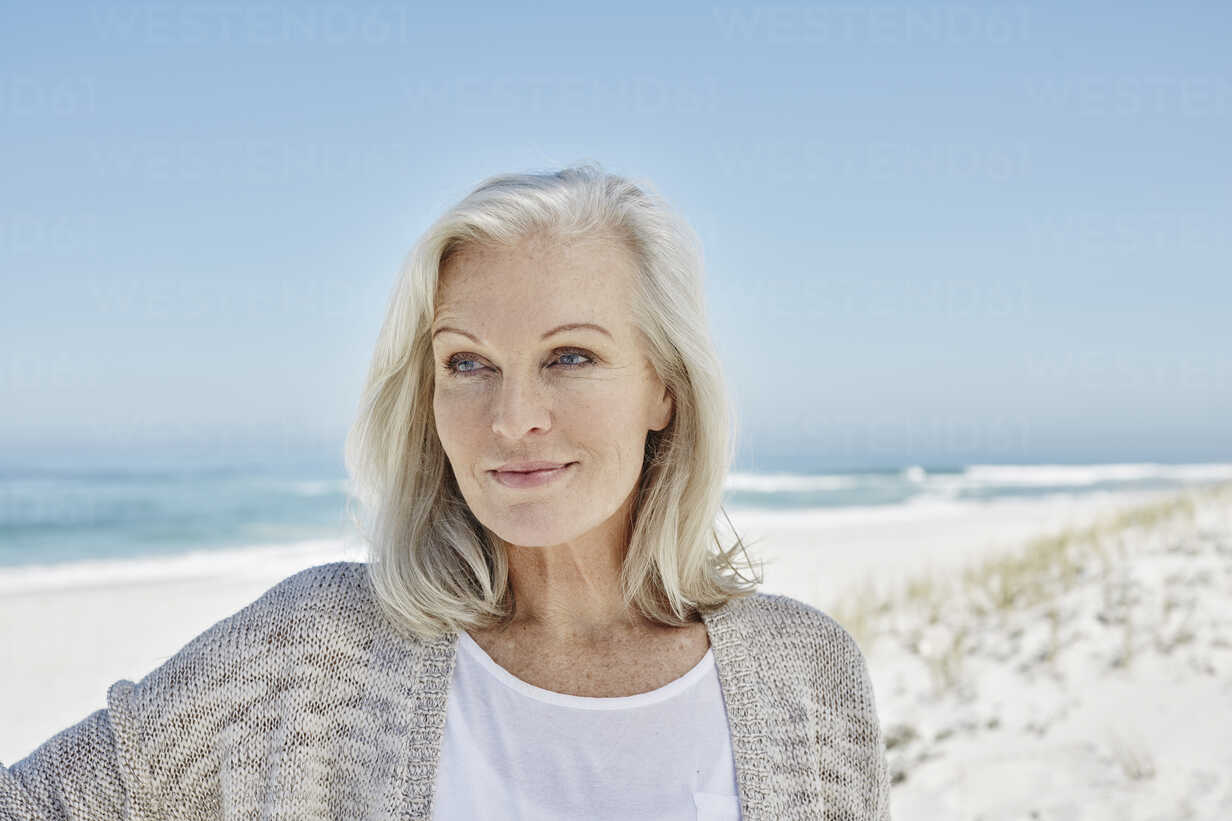 Best ager woman at the beach stock photo