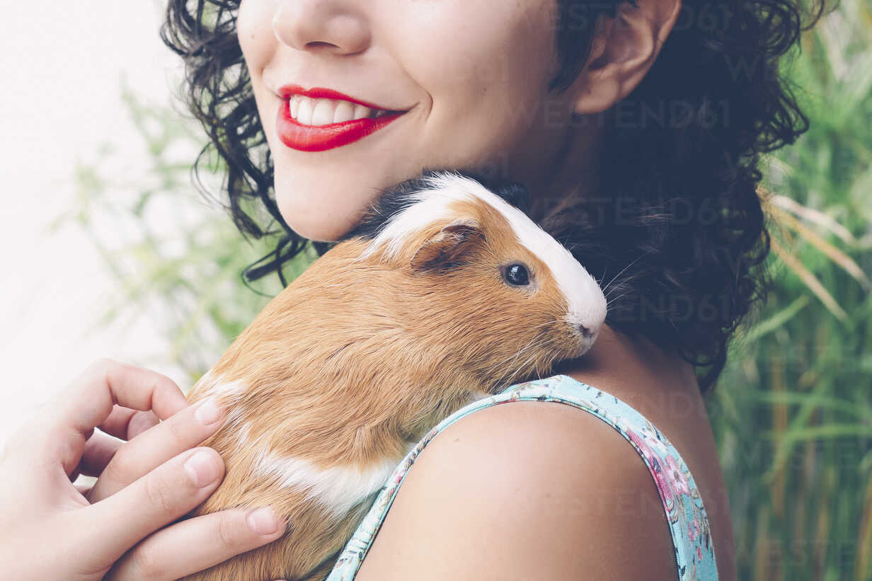 Young woman with Guinea pig on her shoulder – Stockphoto