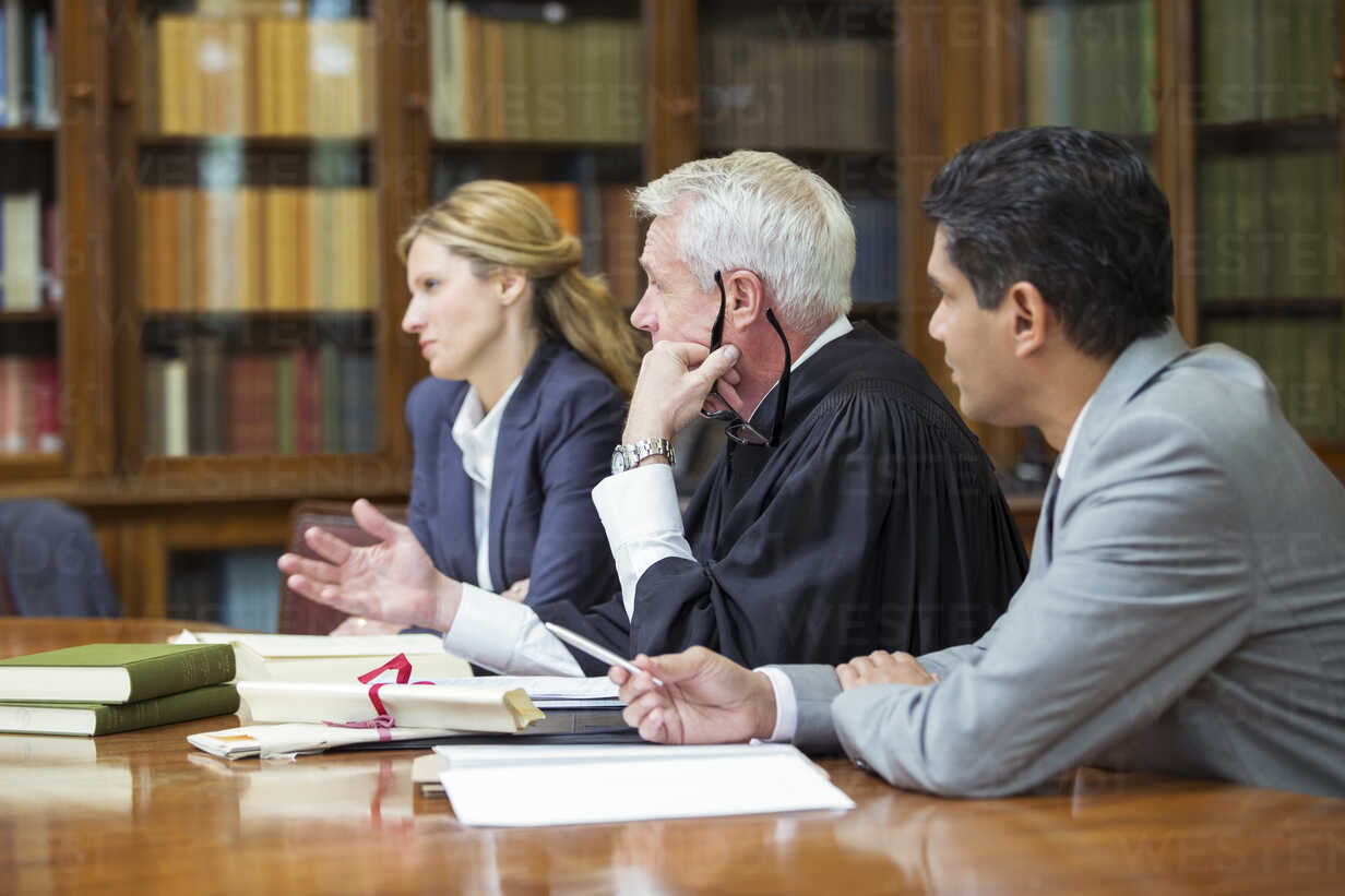 Judge and lawyers talking in chambers stock photo