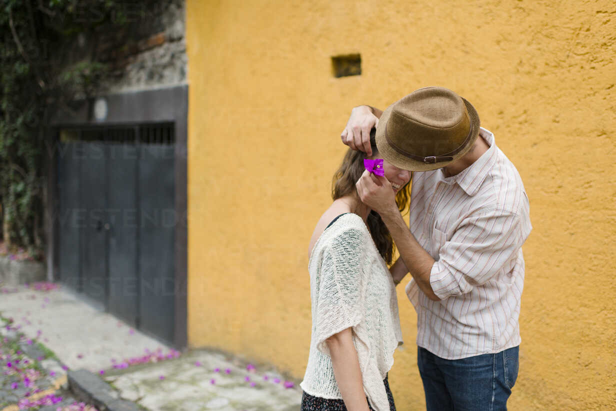 Man putting flower in woman's hair, Mexico City, Mexico stock photo