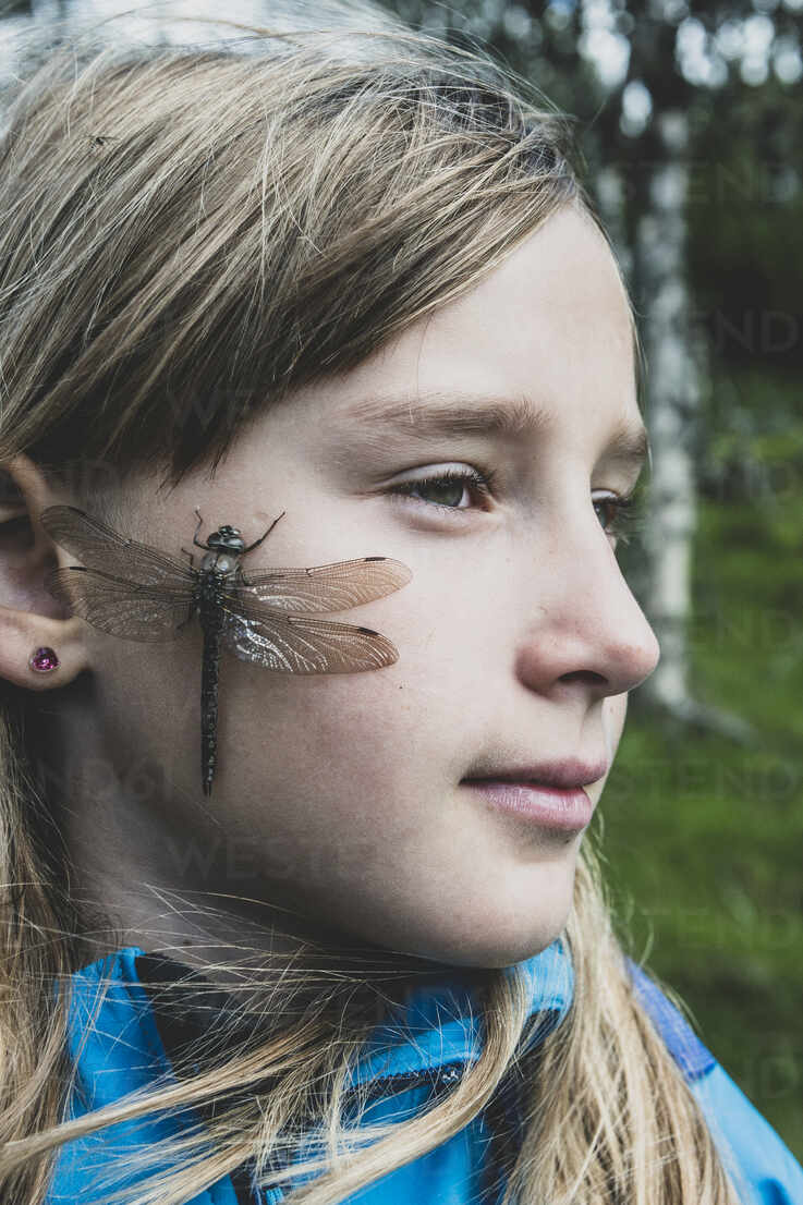 Woman with dragonfly on her face