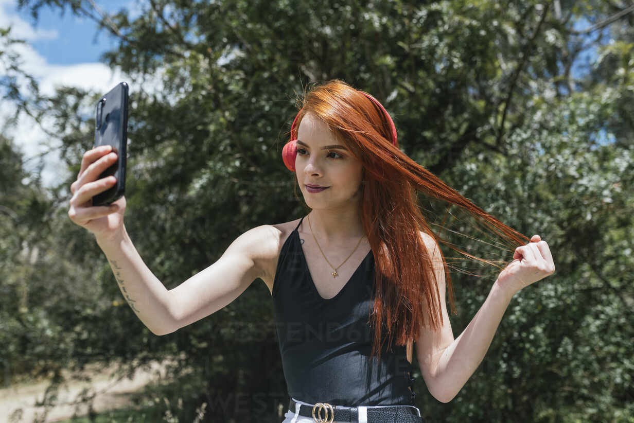 Cute red hair girl making a selfie stock photo