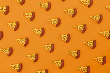 Three dimensional render of pizza slices on orange background stock photo